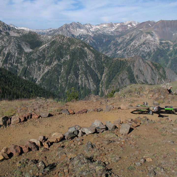 a herd of sheep standing on top of a mountain