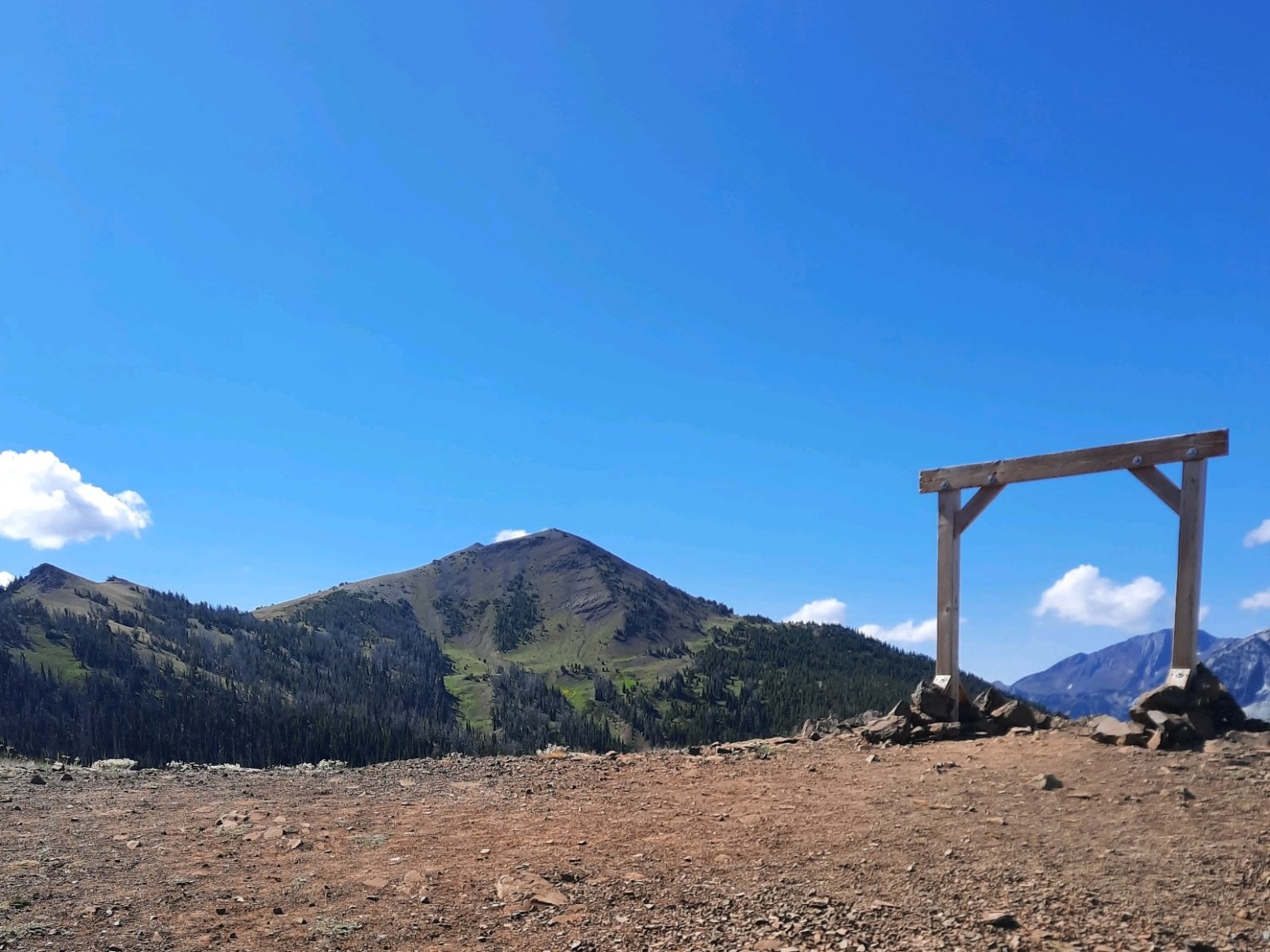 a person that is standing in the dirt with a mountain in the background