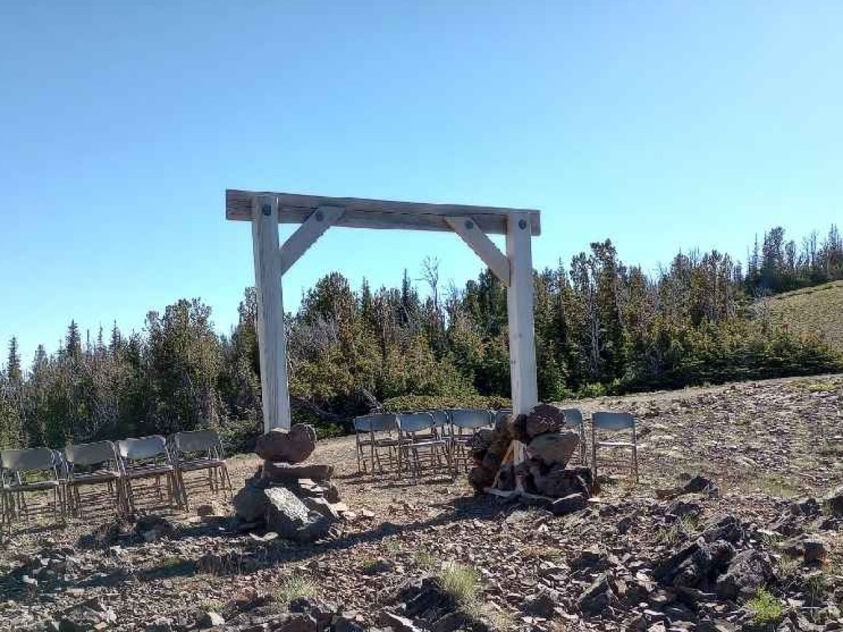 a sign on a dirt field